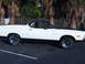 1973 Ford Ranchero - This 1973 Ford Ranchero features a two-tone paint scheme with a white body and black accents on the hood and lower panels.