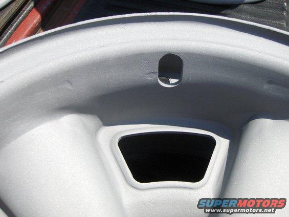Close-up of a gray car wheel rim with a GM logo visible