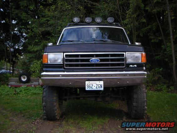 Black Ford Bronco with roof lights and off-road tires, front view