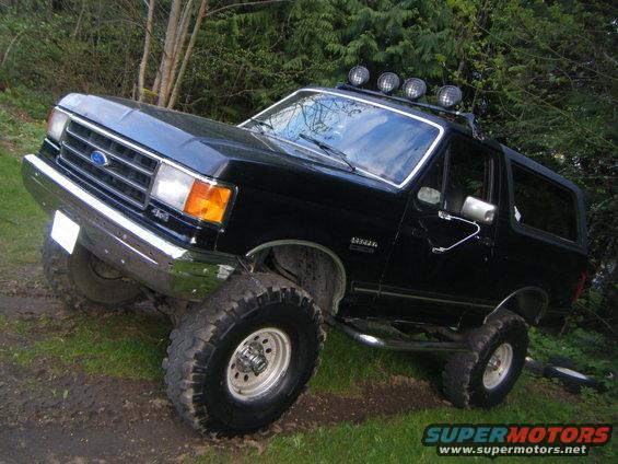 1990 Ford Bronco, black, lifted with off-road tires and roof lights