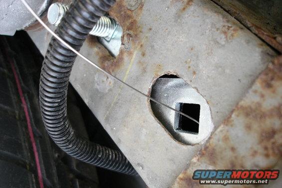 Trailer hitch receiver with a square opening and a wire running through it
