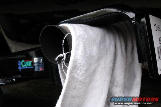 Trailer hitch with a white towel draped over it. Curt logo visible