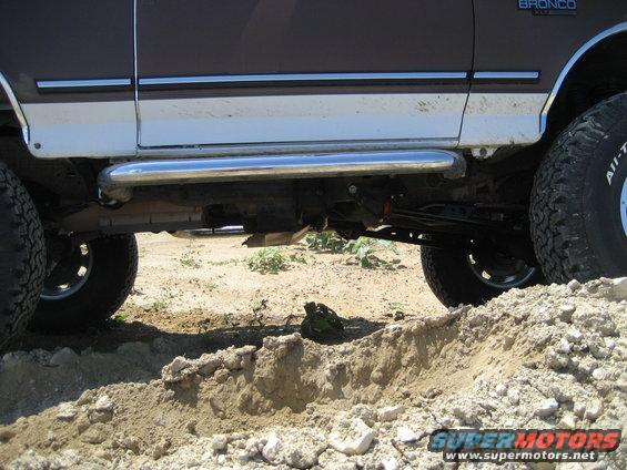 Side view of a 1993 Ford Bronco with chrome side steps and large tires
