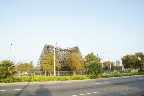 Wooden roller coaster structure against a clear sky