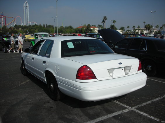 Rear view of a white 2004 Ford Crown Victoria with black wheels