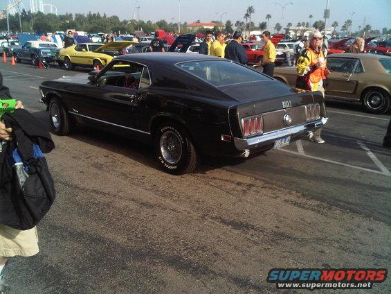 Black 1969 Ford Mustang Mach 1 rear view with Cooper Cobra tires