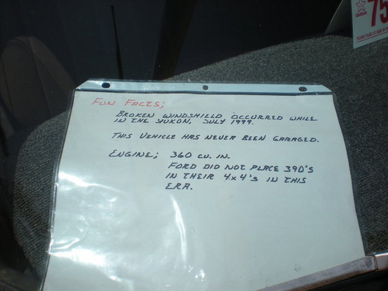 Handwritten notes about a vehicle's history, including a broken windshield in 1999 and engine size