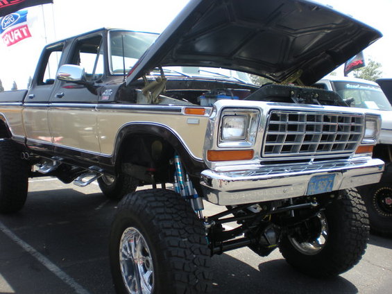 Lifted 1979 Ford F-150 pickup truck, tan and black, hood open, chrome grille
