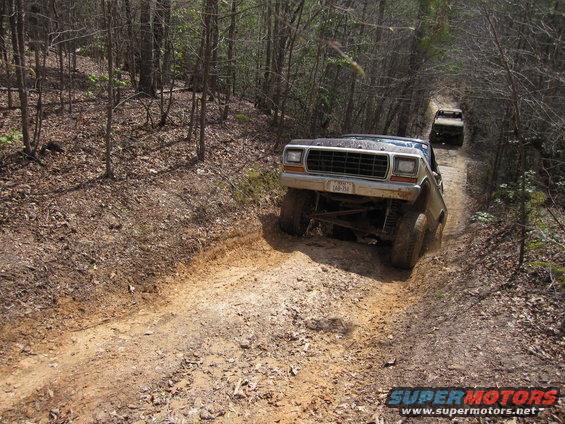1978 Ford Bronco climbing a steep dirt trail, another Bronco follows behind