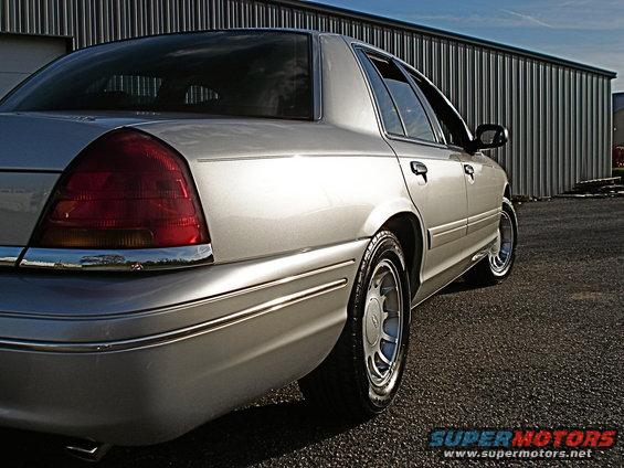 Silver 2000 Ford Crown Victoria rear quarter panel and side view