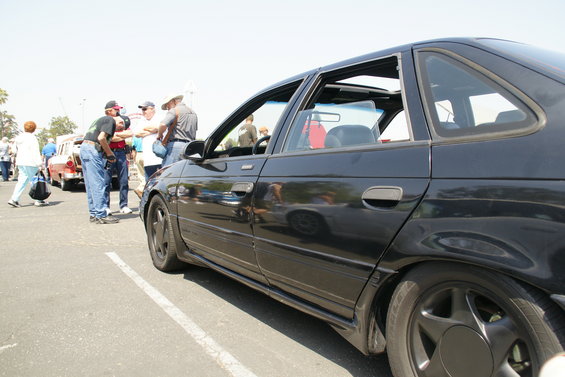 Black 1992 Ford Taurus sedan, side view, with sunroof open