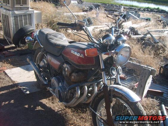 1979 Honda CB750 motorcycle parked outdoors with debris in background