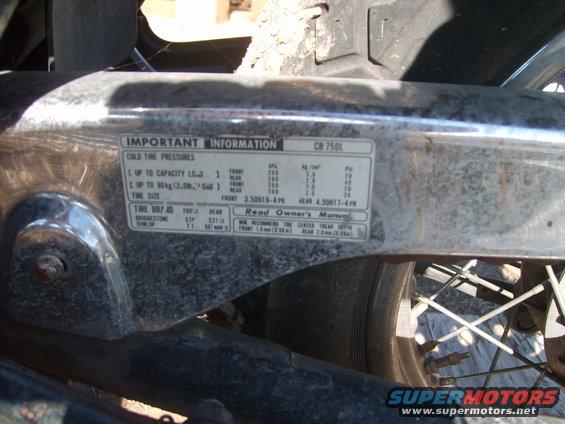 Motorcycle information sticker showing tire pressures and CB 750L designation