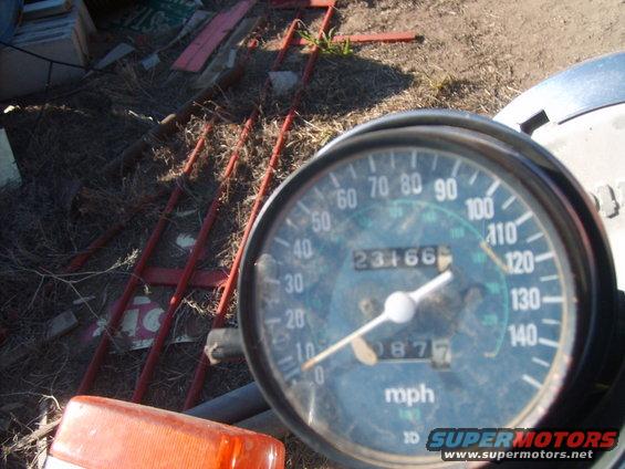 Motorcycle speedometer with odometer showing 23166 miles and trip meter 087