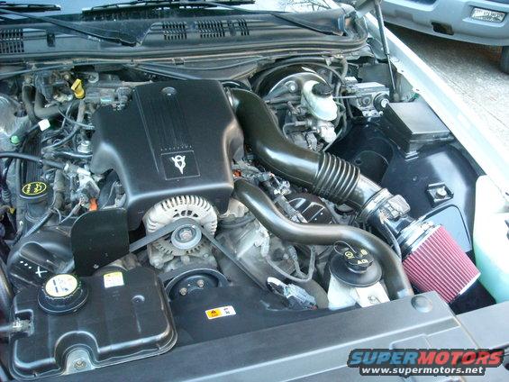 2003 Ford Crown Victoria engine bay with V8 engine cover and aftermarket air filter