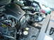 2003 Ford Crown Victoria - The engine compartment of a 2003 Ford Crown Victoria features a V8 engine with an aftermarket air filter.