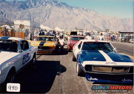 Blue and white AMC Javelin race car with white stripes and 'Javelin' text on front splitter