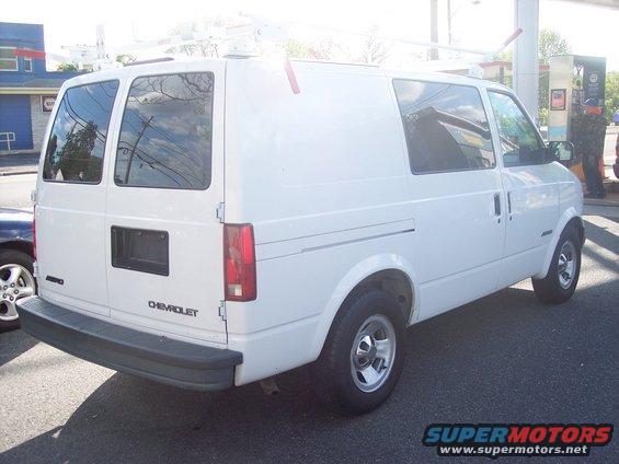 White Chevrolet Astro van, rear view. Roof rack installed
