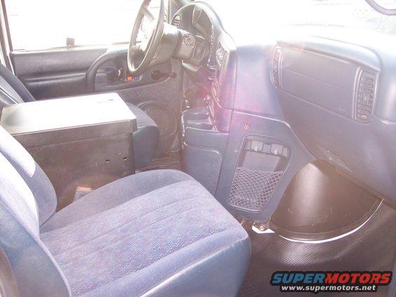 Interior shot of a van, showing the driver's seat, dashboard, and center console