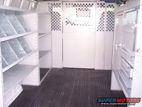 Interior of cargo van with shelving and diamond plate partitions