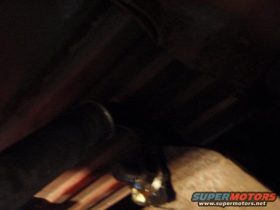 Close-up of a metal suspension component with some grease