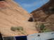 1986 Ford Bronco II - An off-road vehicle navigates a challenging rocky terrain under a bright blue sky.