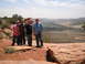 1986 Ford Bronco II - Four men pose for a photo on a scenic overlook in a desert region, with a wide valley stretching out before them.