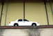 1998 Ford Crown Victoria - Side view of a white 1998 Ford Crown Victoria parked on a raised concrete ledge.