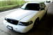 1998 Ford Crown Victoria - This 1998 Ford Crown Victoria is captured from a three-quarter front angle, its clean white exterior.