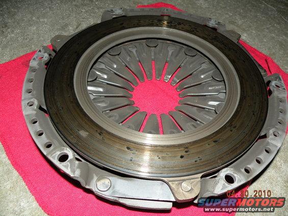 Clutch assembly with pressure plate and diaphragm springs, resting on a red cloth