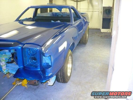 Blue Ford Ranchero in a garage, front end disassembled, undergoing paintwork