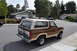 1986 Ford Bronco - This 1986 Ford Bronco is parked on a residential street, showing its brown exterior and tan removable top.