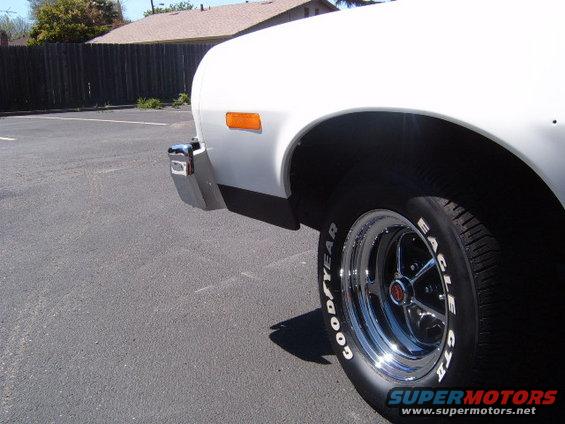 White 1973 Ford Ranchero side view, showing chrome bumper, orange marker light, and Goodyear Eagle GT tires