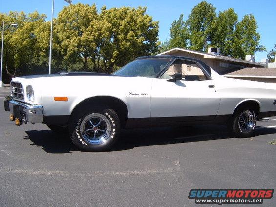White and black 1973 Ford Ranchero side view with aftermarket wheels