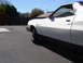 1973 Ford Ranchero - A white 1973 Ford Ranchero is parked in a lot under a clear blue sky.