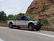 1995 Ford Bronco - This pickup truck features a custom flame graphic on its side and a brush guard on the front.