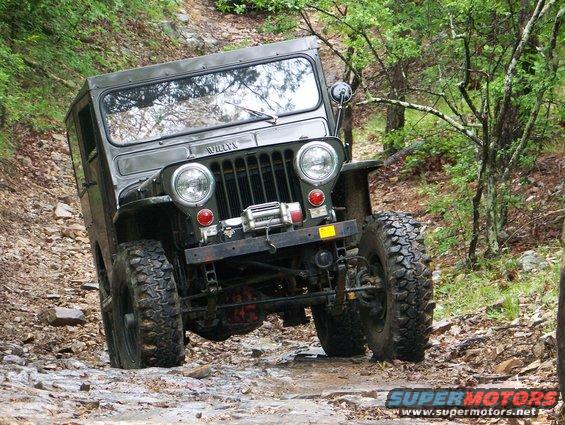 Willys Jeep on a rocky trail, tilted to the side