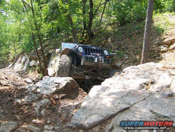 Jeep Wrangler navigating a rocky trail, 4WD engaged