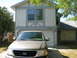1983 Ford 427 - A tan Ford F-150 pickup truck is parked in the driveway of a house.