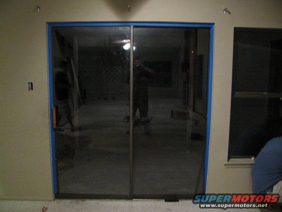 Sliding glass doors in a room with concrete floor and unfinished walls