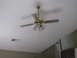 1983 Ford 427 - A brass ceiling fan with lights is shown from below, with its blades blurred from motion.