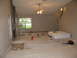1983 Ford 427 - This room appears to be undergoing renovations, with a mattress and various supplies scattered around.