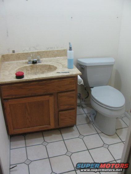 Bathroom with vanity, sink, toilet, and tiled floor