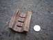 1971 Ford Ranchero - A weathered wooden component with carved slots is shown next to a coin on a dark, textured surface.