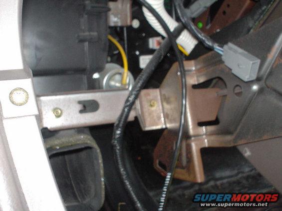 dsc00487.jpg This is a picture of the stuff behind the shifter. This shot was taken from rightwhere the floor shifter knob would be facing forward. The open air duct you see is the one for the passenger vents in the back.