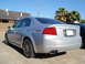 2003 Acura TL - Rear view of a silver 2003 Acura TL sedan, its taillights, exhaust, and alloy wheels.