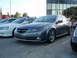 2003 Acura TL - A gray 2003 Acura TL is parked in front of a modern building, with other vehicles nearby.