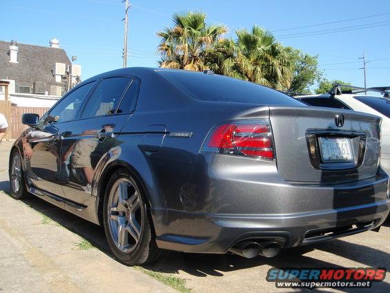 Dark gray Acura TL sedan, rear quarter view. License plate FYH-561