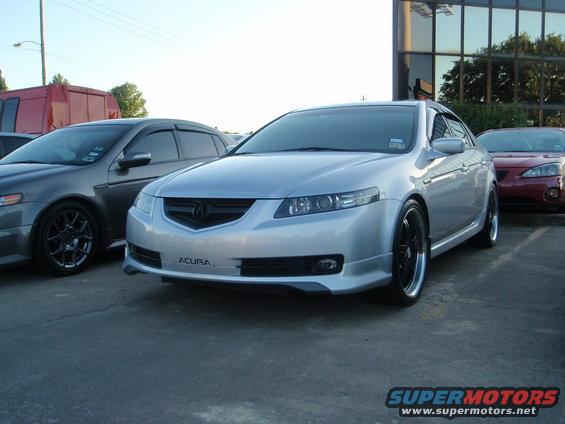 Silver Acura sedan with black rims, front-left view