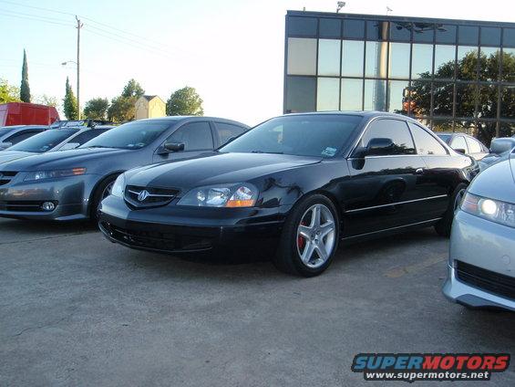 Black Acura CL coupe parked next to other cars, including a silver Acura sedan